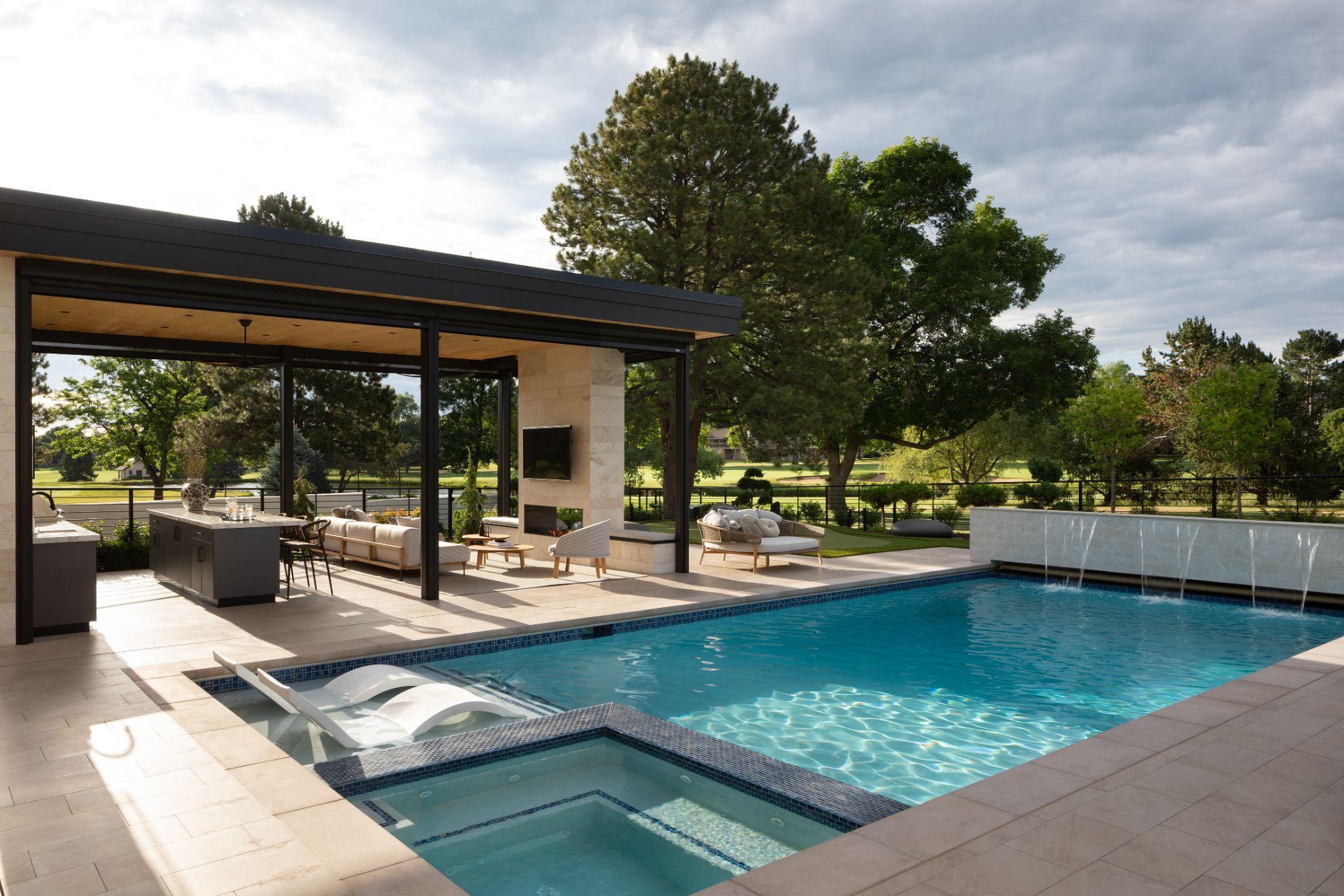 Modern poolside patio with covered lounge and outdoor kitchen