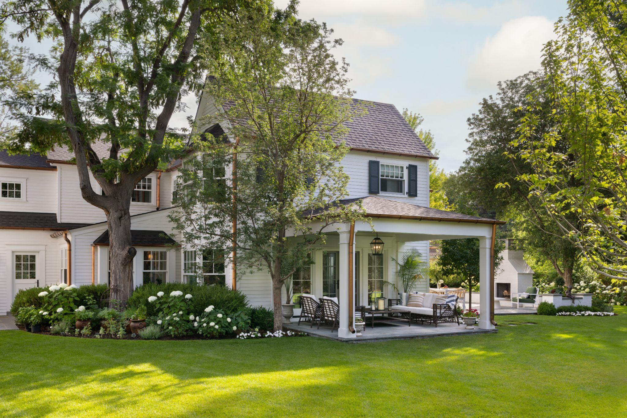 Pergola for shade on patio at traditional white home