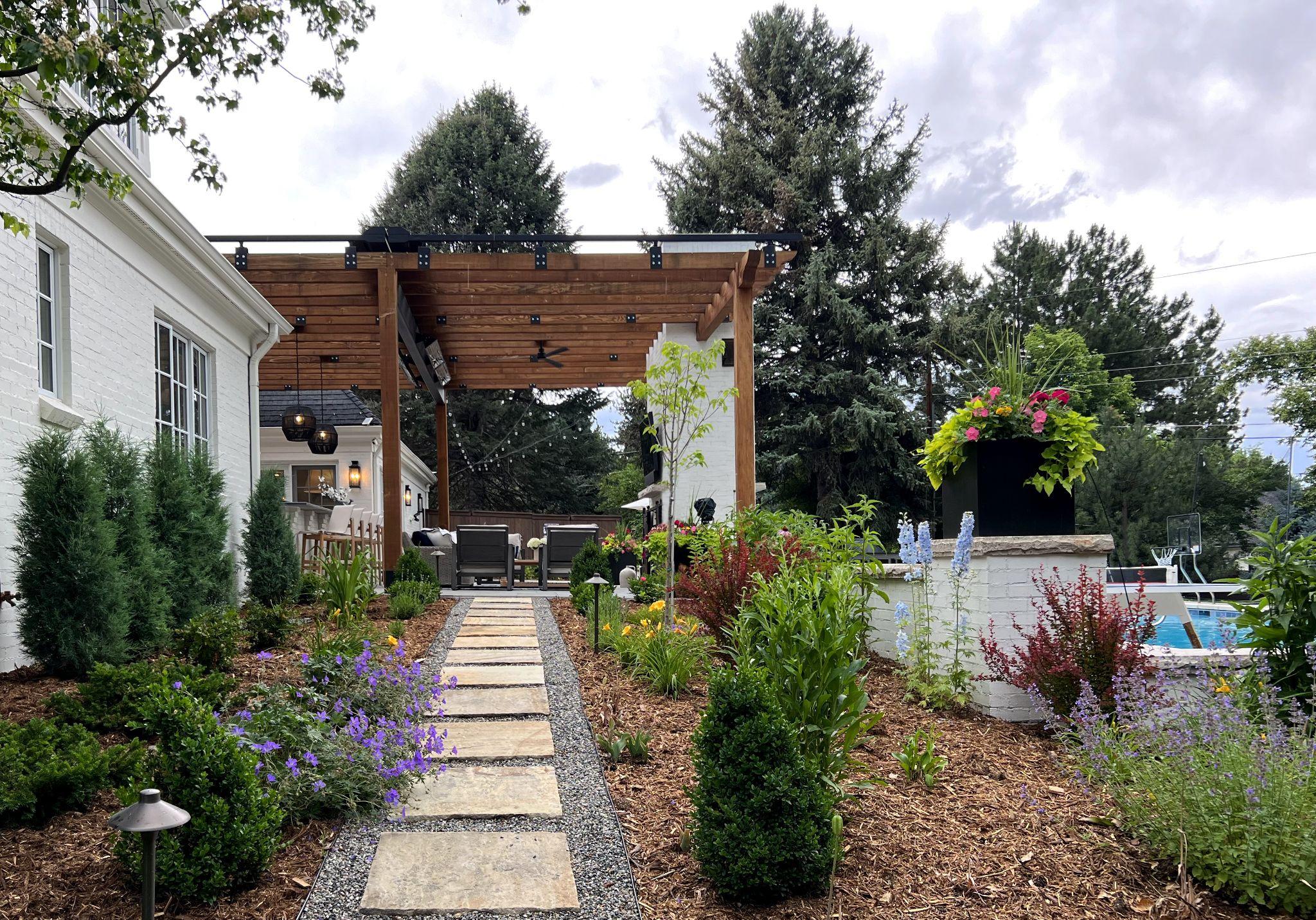 Wood pergola patio with garden path and layered plantings